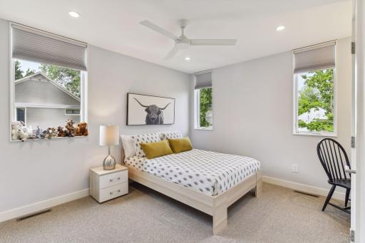 Second upper level bedroom with recessed lighting, ceiling fan and large closet.