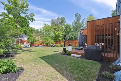 Spacious level backyard is tastefully landscaped with a beautiful full cedar privacy fence.
