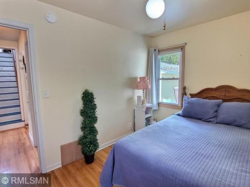 The second bedroom on the main level offers closet, ceiling fan, and wood flooring. New windows installed throughout the home in 2008.
