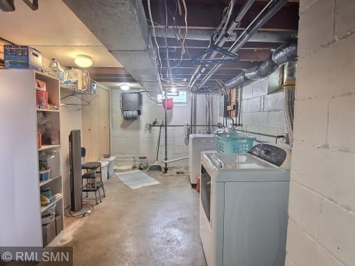 Great space for a laundry room! Shelving, large closet, and sink. The laundry room extends into another storage area. Utilities are located within the room as well.