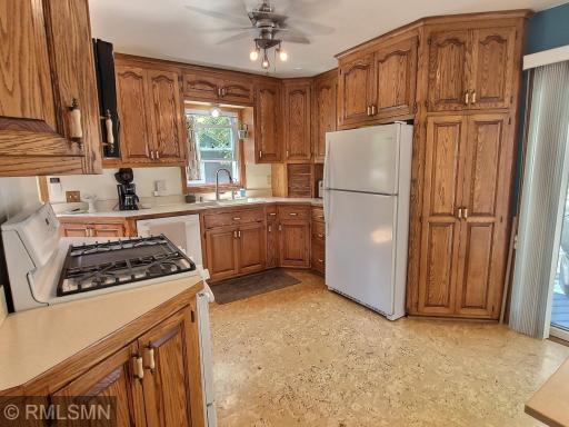 Enter through the side door and be amazed at the oak cabinets, and newer fridge and dishwasher. Great open concept welcomes you to step outside to the deck.