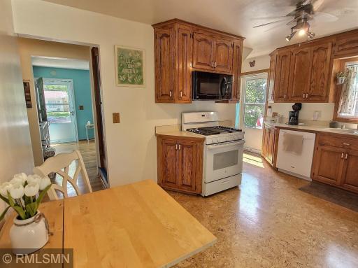 The kitchen offers cork flooring and ample cabinet space, easy flow from the kitchen and dining room into the rest of this charming property!