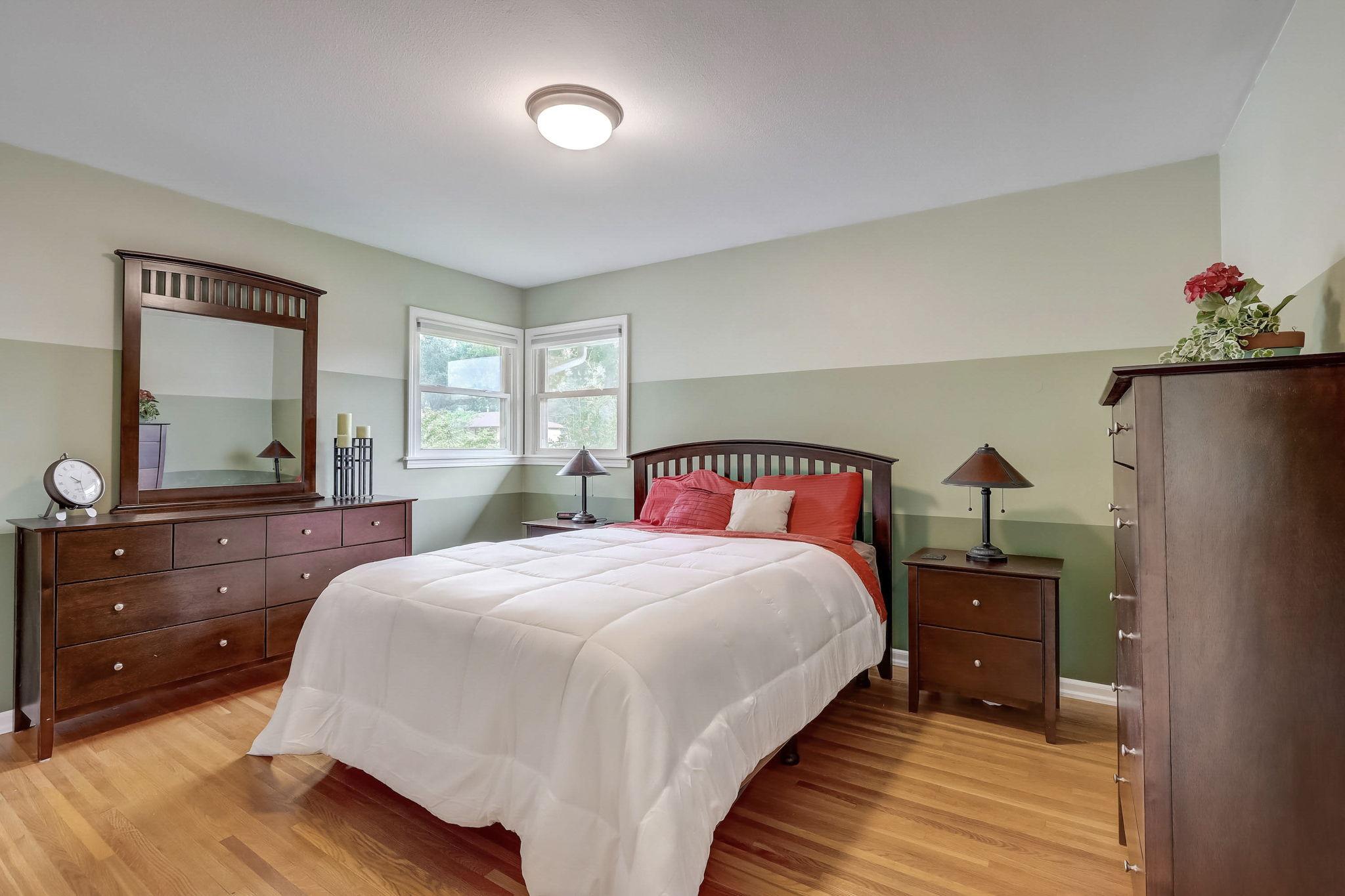 Three bedrooms on the main level, including a roomy primary bedroom with dual closets for ample storage, and hardwood floors throughout all the rooms!