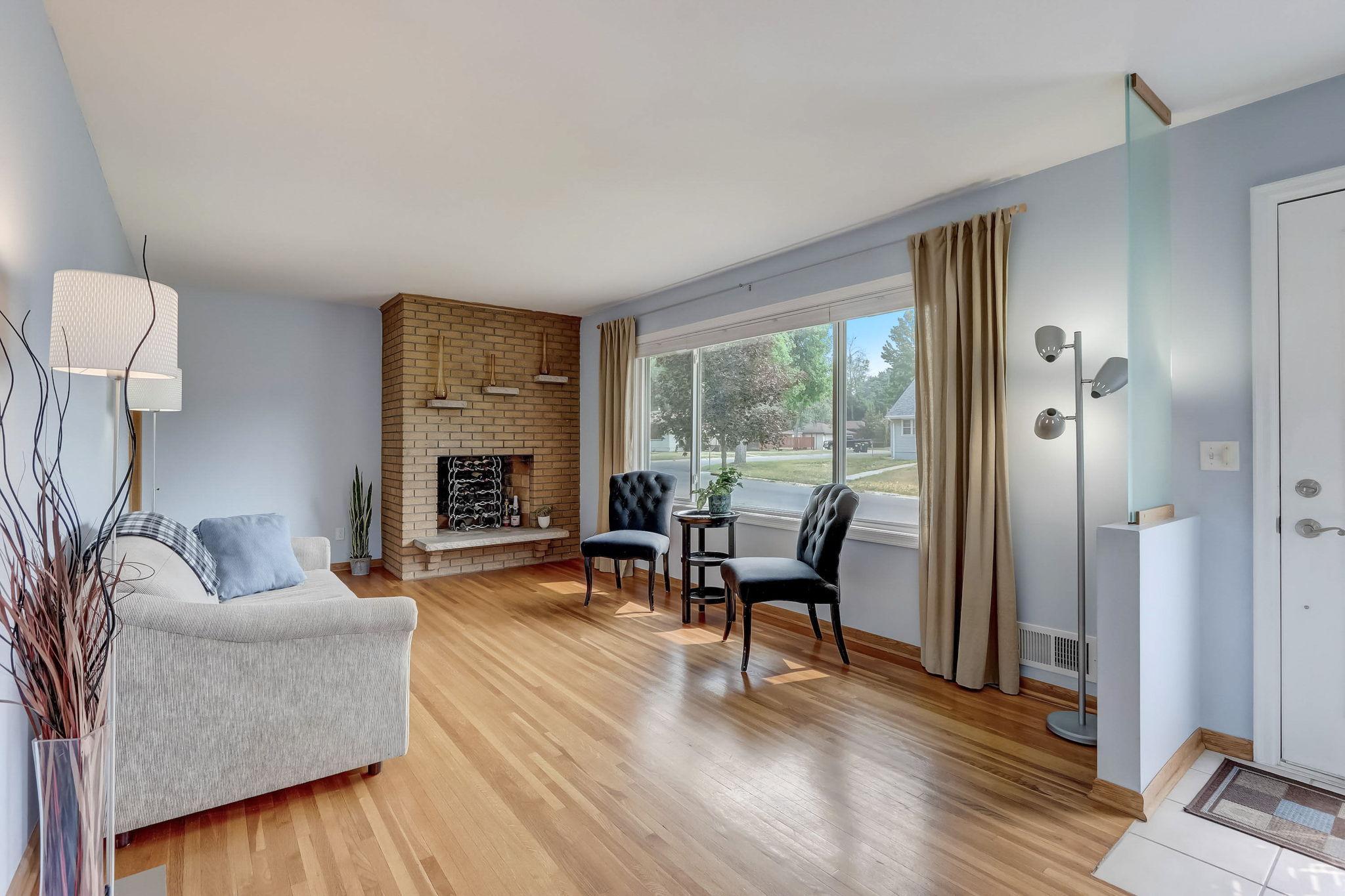 A floor to ceiling brick fireplace provides a great focal point, and a huge picture window allows natural sunlight to pour in!