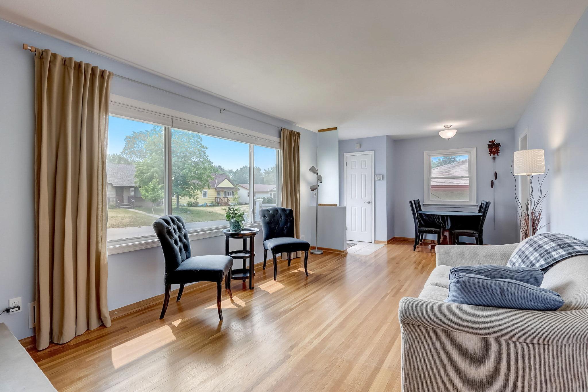 Spacious sun-filled living room provides a wonderful first impression! Gleaming hardwood floors extend throughout much of the main level. Plenty of space to have a dining table in this space also! Nearby tiled entry with a closet.