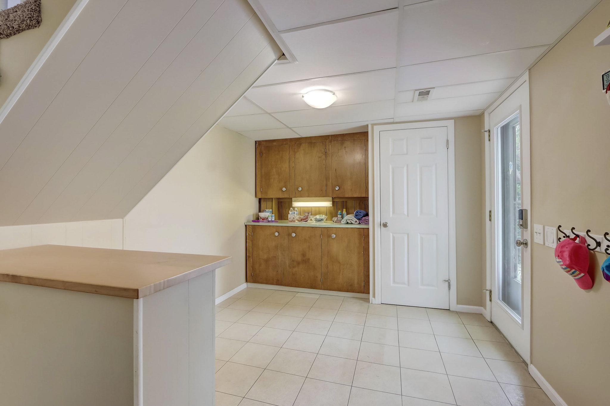 Handy snack bar or mudroom area with a storage or coat closet located right near the exit to the backyard!