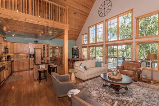 Massive lakeside windows and sliding glass doors bring in the outdoors, access to the deck, the view and sunsets.