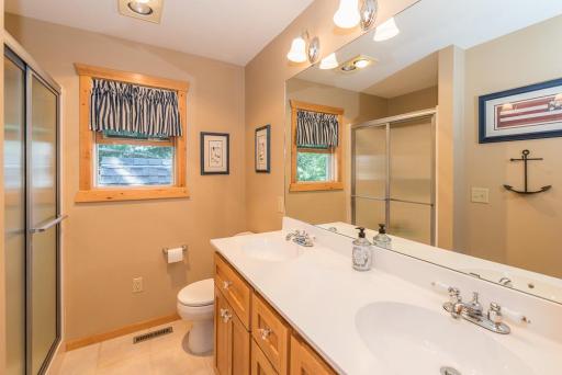 The upper level bathroom has a double vanity and shower.