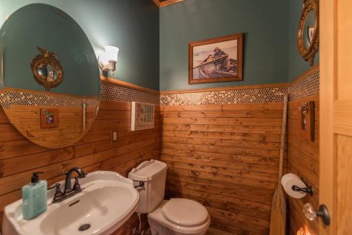 Guest bath with stunning tile floors and wainscot.