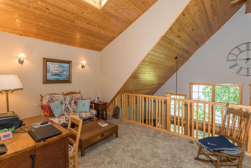 There is a cozy loft which serves as another gathering area or office.