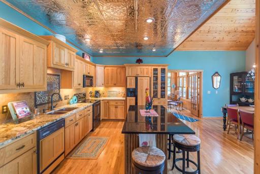 The kitchen has a large center island , granite countertops, a 2 compartment copper sink, an attractive backsplash, and a large closet pantry.