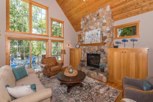 The greatroom has a stunning floor to ceiling gas stone fireplace and built in cabinets on each side.