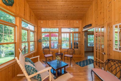 This bright and light 4 season sunroom gives you the first glimpse of the water.