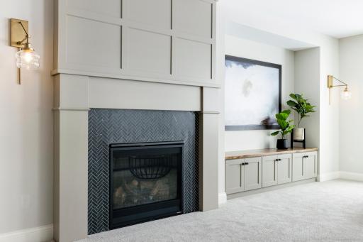 Lower Level Fireplace Detail with TV area *photo of like home