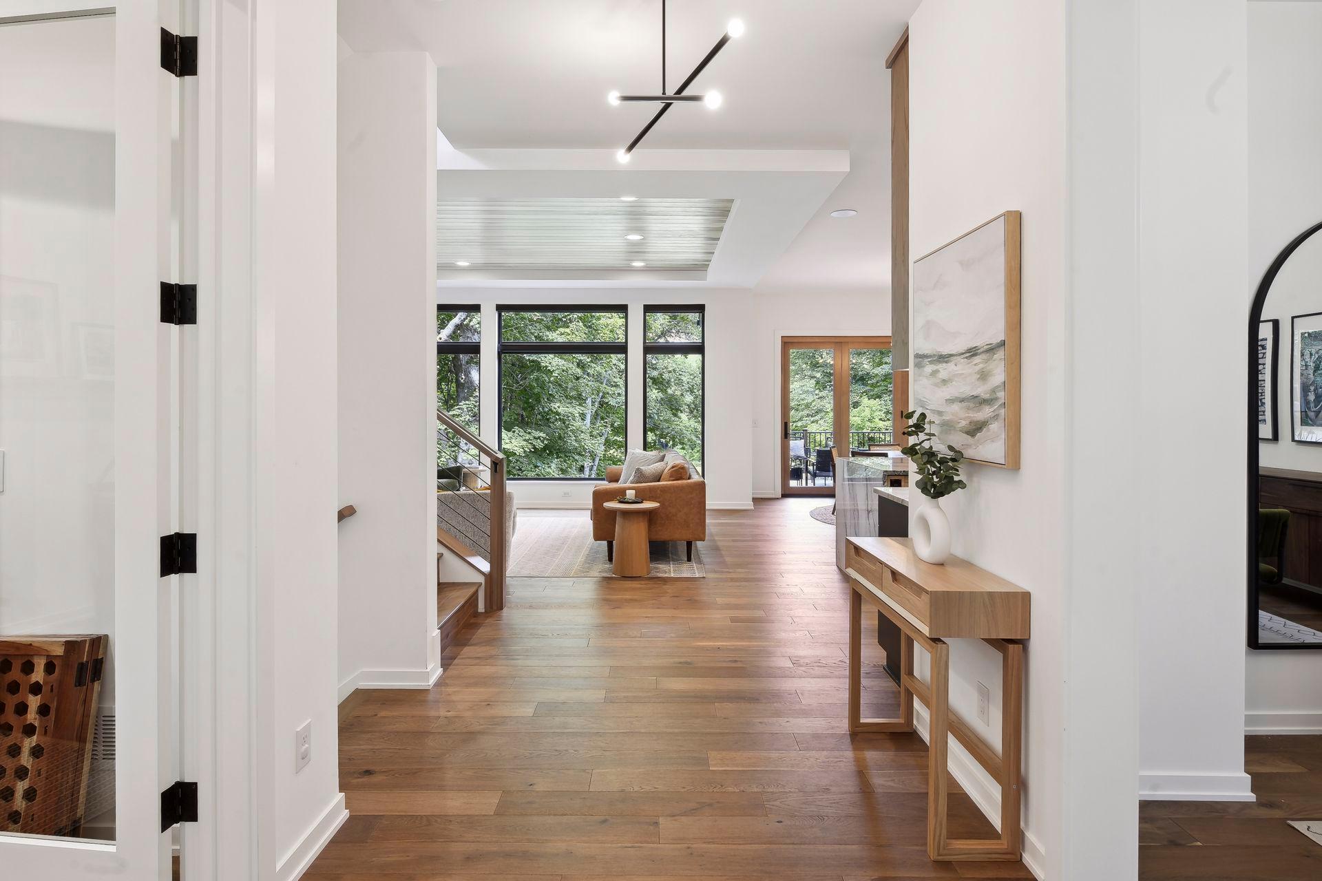 Hardwood floors on main and upper levels are complemented by large picture windows that invite the outside in