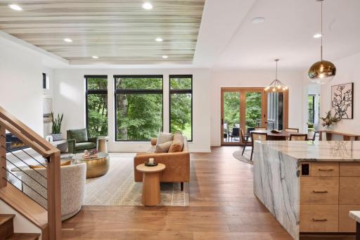 Hardwood floors on main and upper levels are complemented by large picture windows that invite the outside in