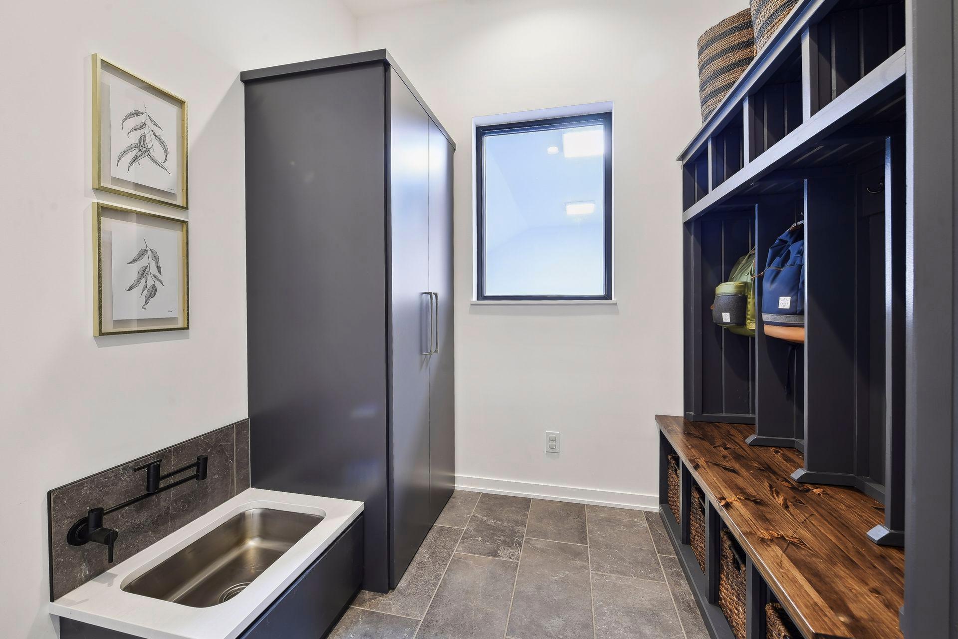 Mud room cubbies and storage make an easy entrance from the garage, which has both heating and drains
Special consideration was given to family pets, who have their own custom built-in water bowl / dog wash in the mudroom.