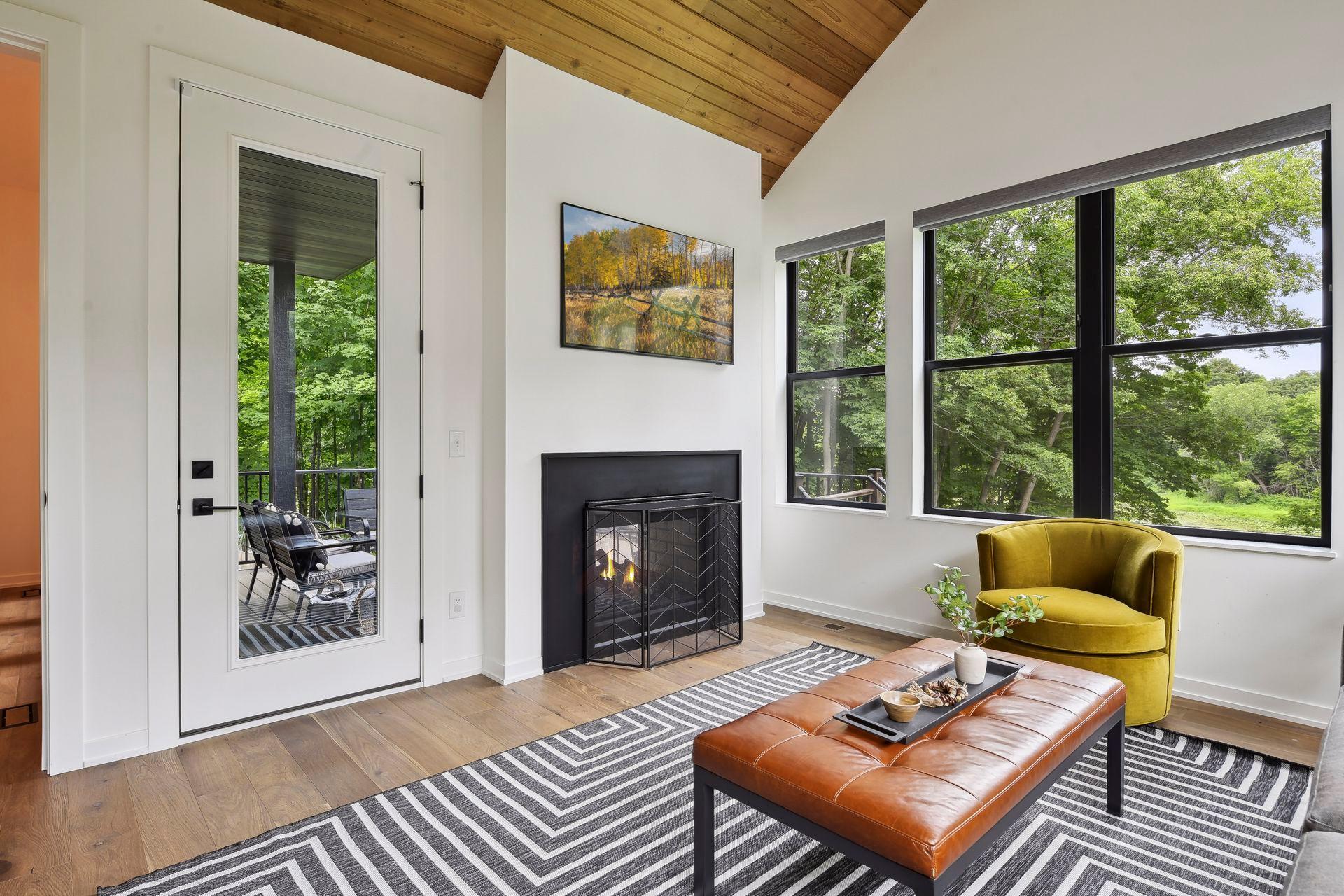 Access to the deck. The two-sided fireplace allows for extended use of the deck in the Spring and Fall.