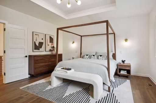 The generous primary suite features two walk in closets with upscale finishes. Oversized windows allow for beautiful views of the private backyard and Lake William.