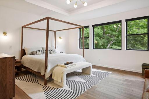 The generous primary suite features two walk in closets with upscale finishes. Oversized windows allow for beautiful views of the private backyard and Lake William.