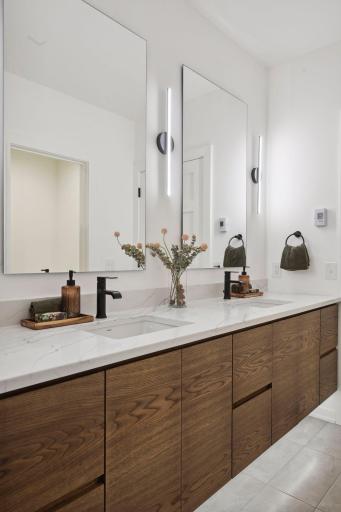 All full and 3/4 baths enjoy heated floors, quartzite countertops and generous vanity space.