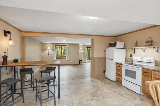 Kitchenette with new appliances and tile flooring - potential for Mother-In-Law suite or guests.