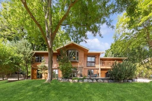 Lush landscaping and mature trees cascade the property.