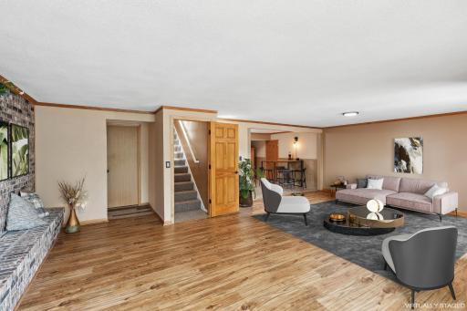 Retreat to the family room featuring a lovely brick feature wall with fireplace, spacious space for gathering and entertaining. Virtually staged.