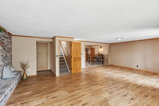 Retreat to the family room featuring a lovely brick feature wall with fireplace, spacious space for gathering and entertaining. Without virtual staging.