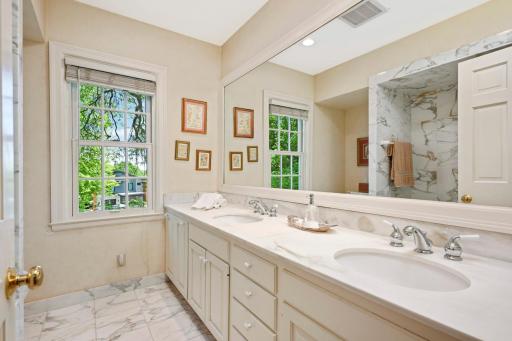 Full primary bath with double sinks and Carrara marble tile