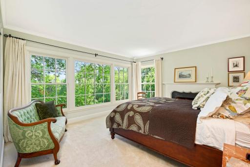 Main floor Primary suite has a wall of windows to the backyard