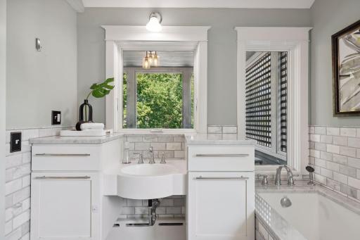 Photo for 2708 Irving Avenue S, Minneapolis, MN 55408 - Listing #6391325 Second floor sink, vanity and tub with views of the lake