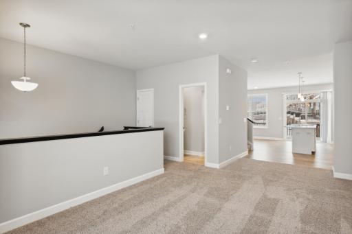 Large livingroom with a 1/2 bath, open to the the kitchen and family room. Great space for entertaining! Photos are not of actual home. Actual home will be similar. Some colors and features may vary.