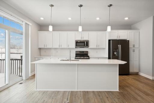 Great kitchen for entertaining or family gathering. Photos are not of actual home. Actual home will be similar. Some colors and features may vary.