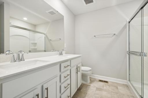 Private owner's suite bath with double sinks. Photos are not of actual home. Actual home will be similar. Some colors and features may vary.
