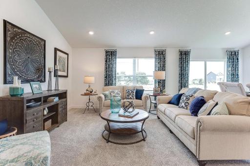 Light and bright family room has high ceilings but a cozy feel.