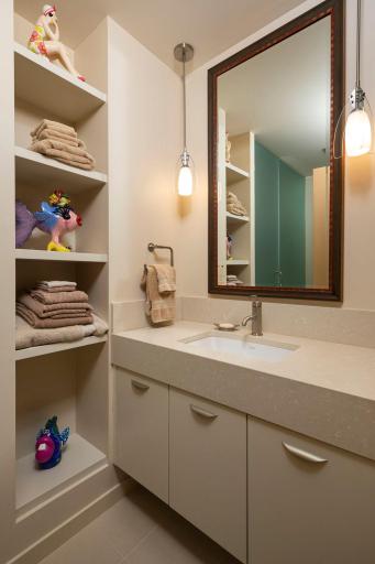 Guest bathroom vanity with custom shelving and pendant lighting.
