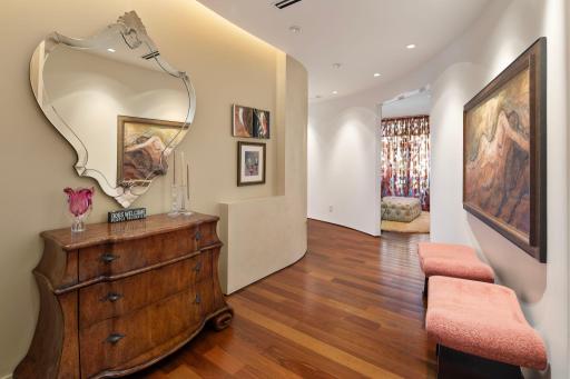 Pocket doors open to den/sitting area with curved main hallway and built in ledge.