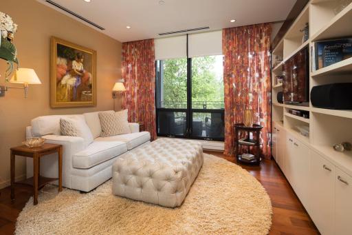 Elegant den/sitting room directly adjacent to the master bedroom with custom glass pocket doors for privacy.