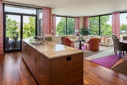 Enjoy panoramic views from the floor to ceiling windows, featuring custom shades with many different operating options. Kitchen is open to living area, promoting a welcoming feel.