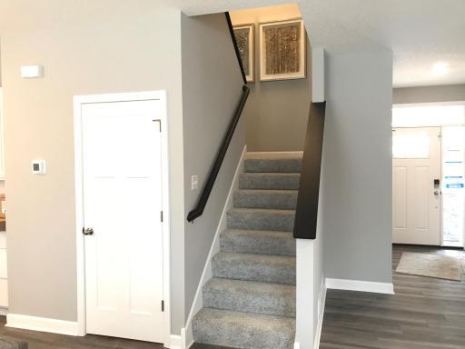 Elegant staircase to the upper level has four bedrooms and two baths. Previous home, finishes will vary.
