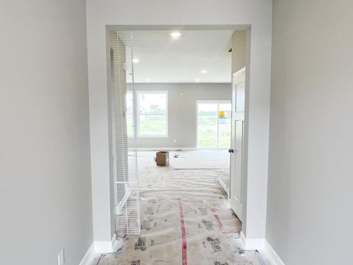 Front entry flows toward main level guest suite and family room.