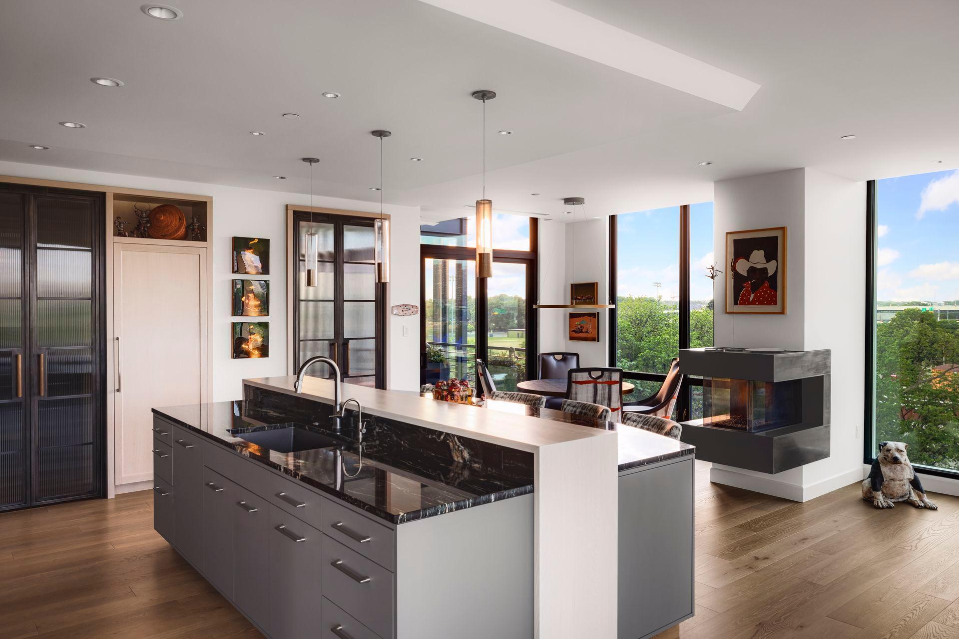 The primary kitchen island boasts a raised oak waterfall division between work area and seating.