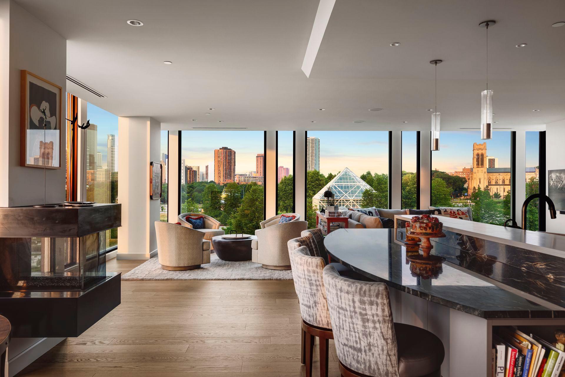 Counter seating backs the generous kitchen island. Notice the artisan crafted steel fireplace which complements the range hood and custom doors.