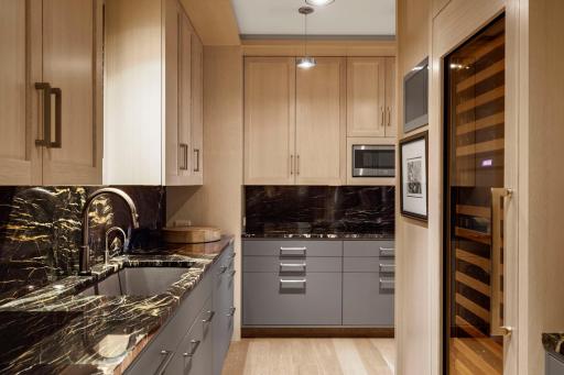 Note the deep Blanco sink and second dishwasher. The Sub-Zero wine refrigerator holds 146 bottles. A flush mount Seura TV and ceiling speakers add to the enjoyment.