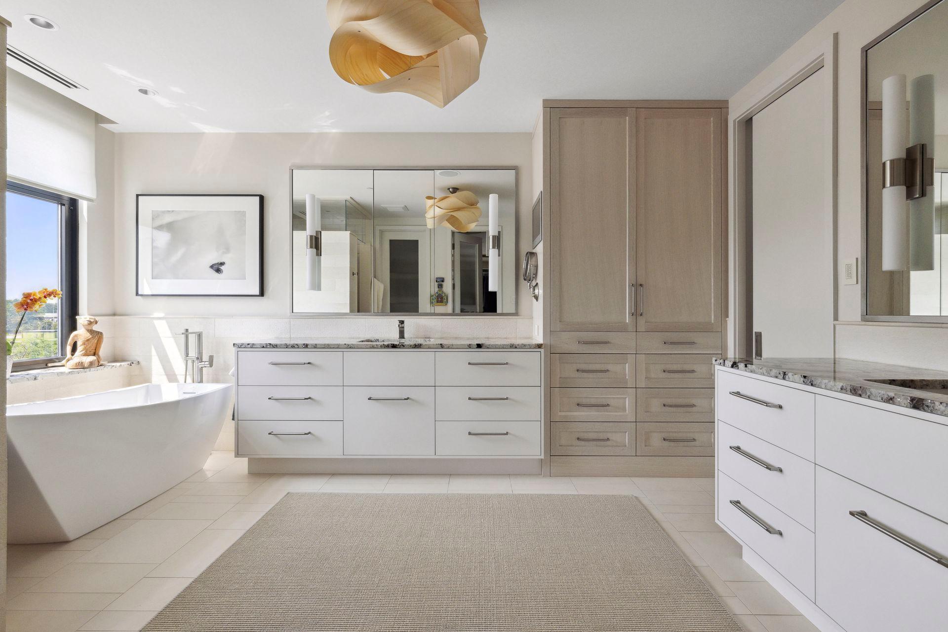 The primary bath boasts generous storage and a built-in Seura TV to enjoy from your tub.