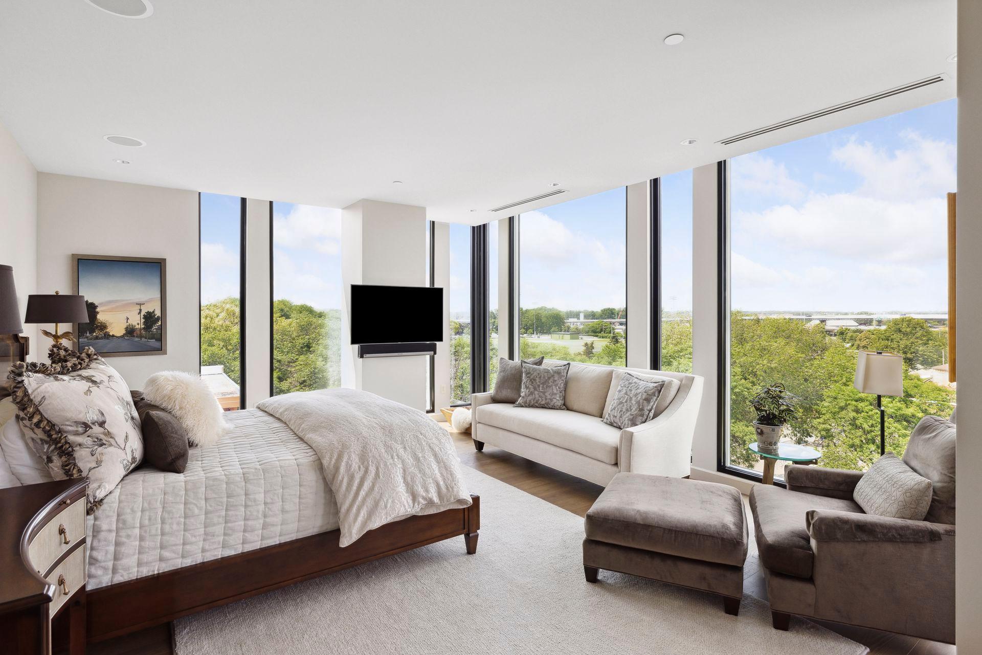 Three walls of glass give the primary bedroom amazing exposure morning and night.