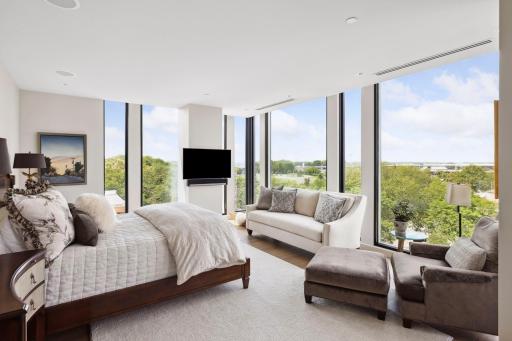Three walls of glass give the primary bedroom amazing exposure morning and night.