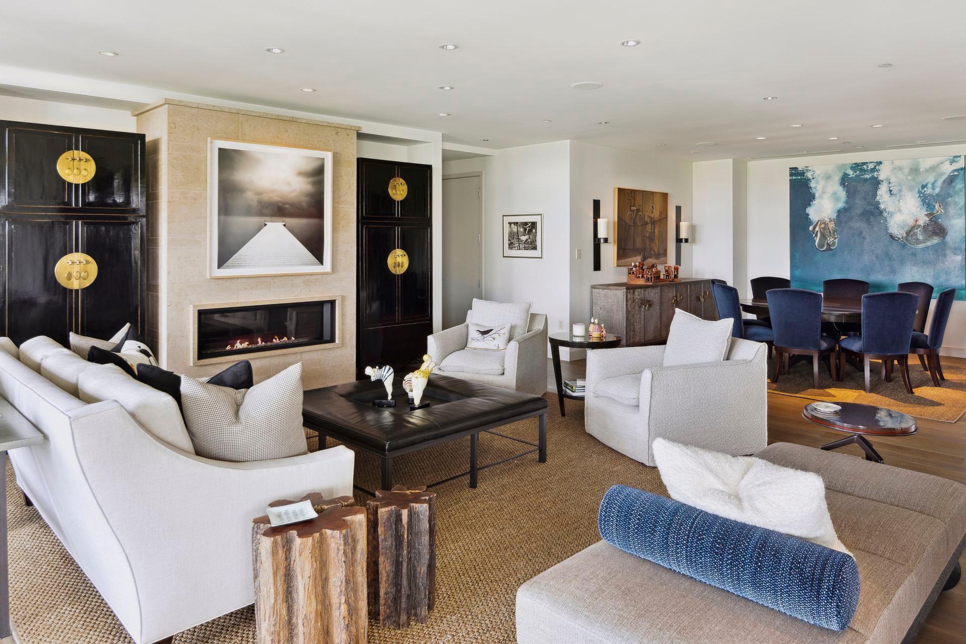 The living room features a large gas fireplace with limestone surround floor to ceiling and a lovely wet bar.