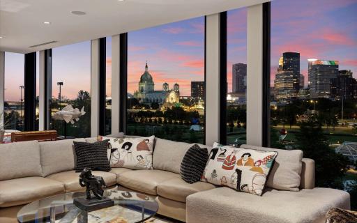 The night skyline glows with iconic buildings.
